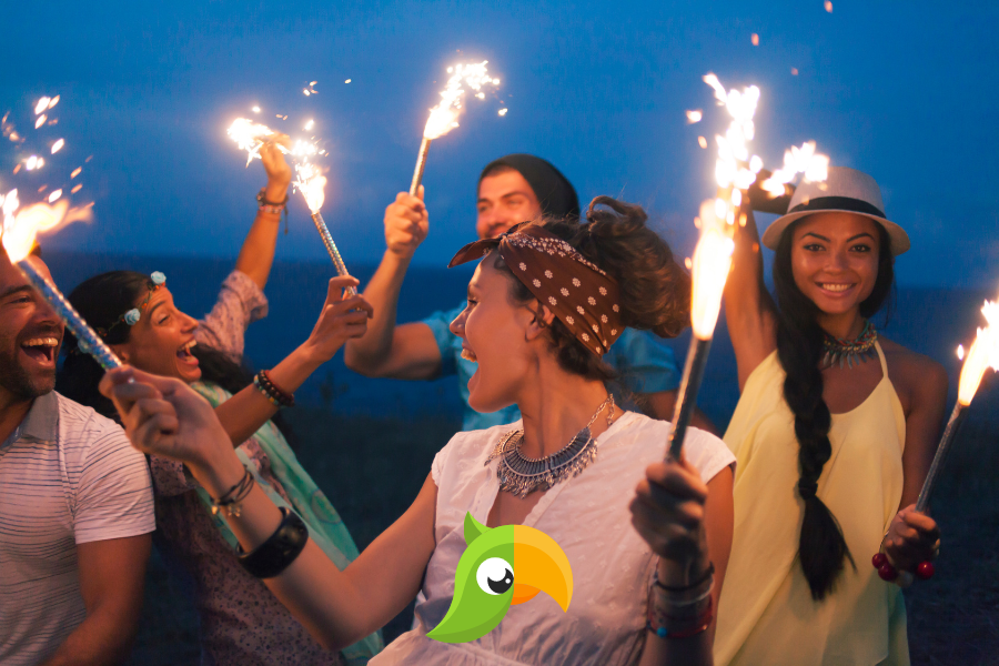 people on a beach at night with sparklers with interpolly logo at bottom